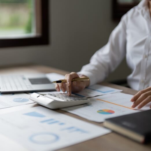 Business woman using calculator for do math finance in office, tax, accounting, statistics and analytic research concept