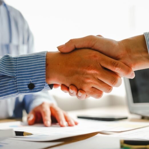 Businessman conducts financial discussions, sealing deals with handshakes. Expert in accounts, loans